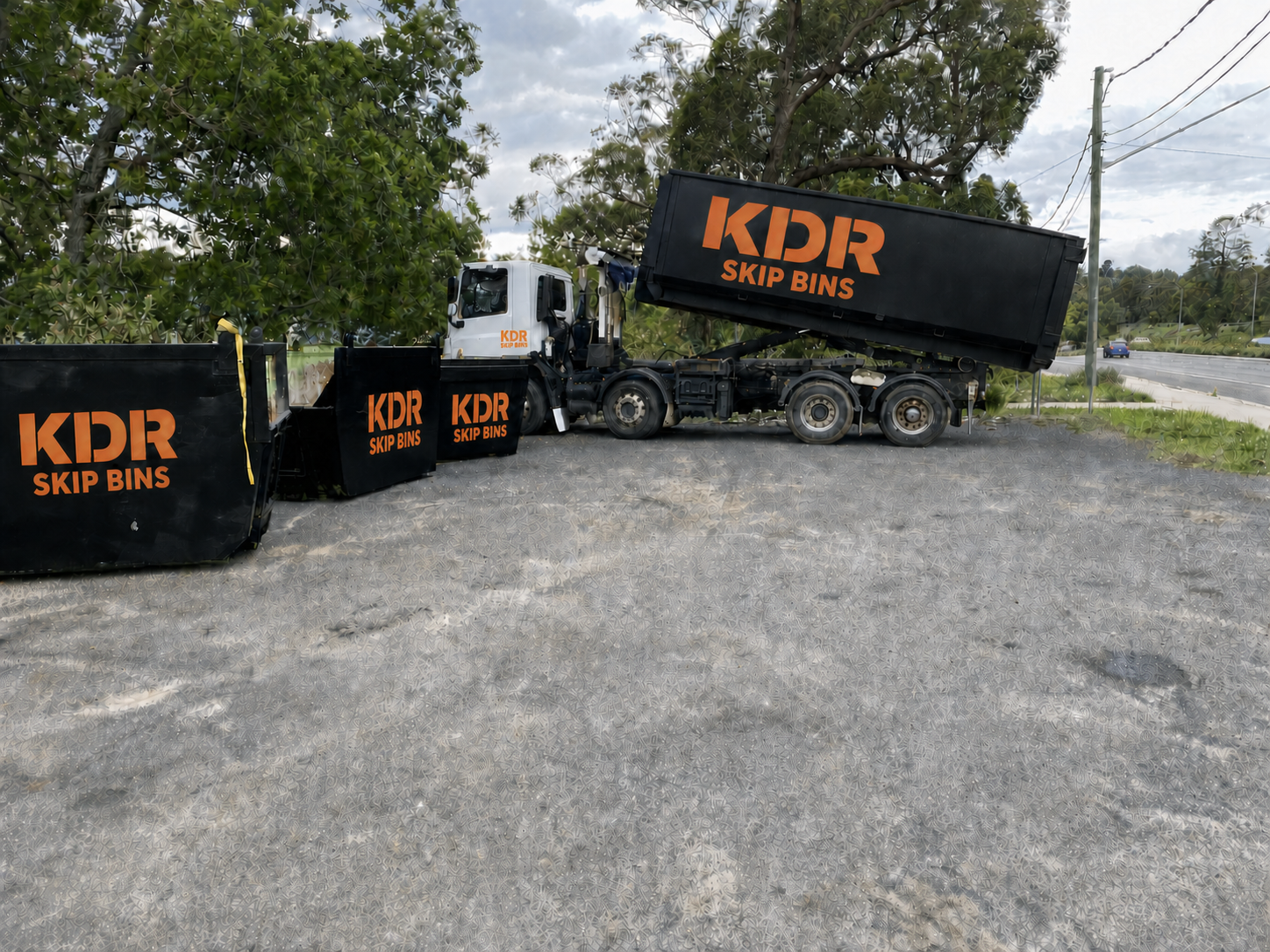 KDR Skip Bins hook-lift truck with three skip bins parked alongside